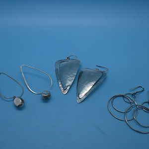 Three sets of silver earrings.